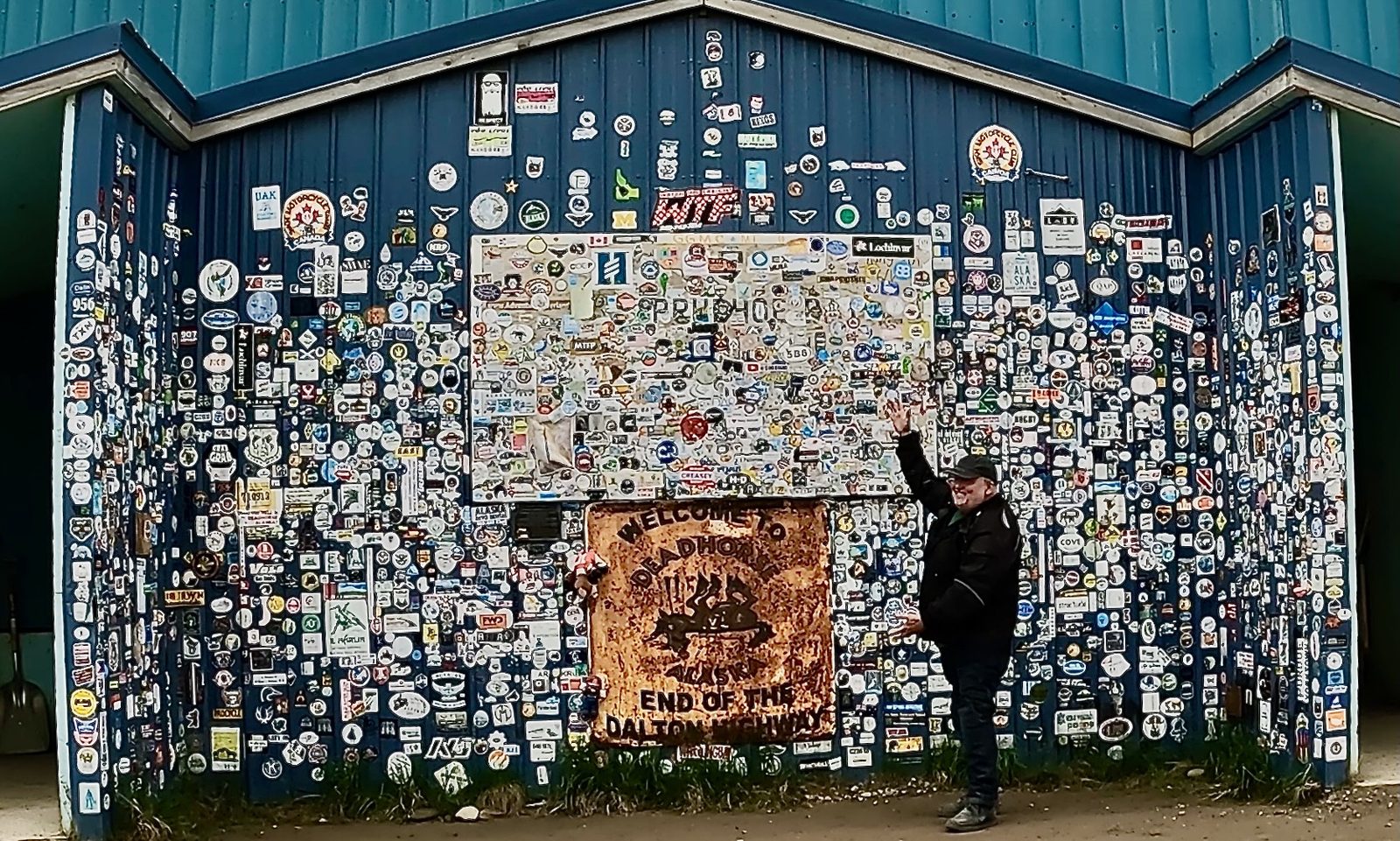 The sticker-covered wall at the end of the Dalton Highway in Deadhorse